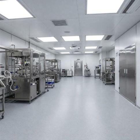 Controlled production room with process machinery, flush ceiling lights and a stainless-steel double door